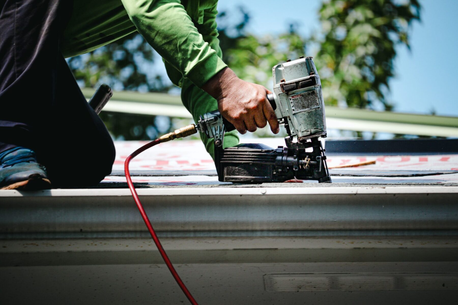 Stonecreek roofing crew member using nail gun on the phoenix roof